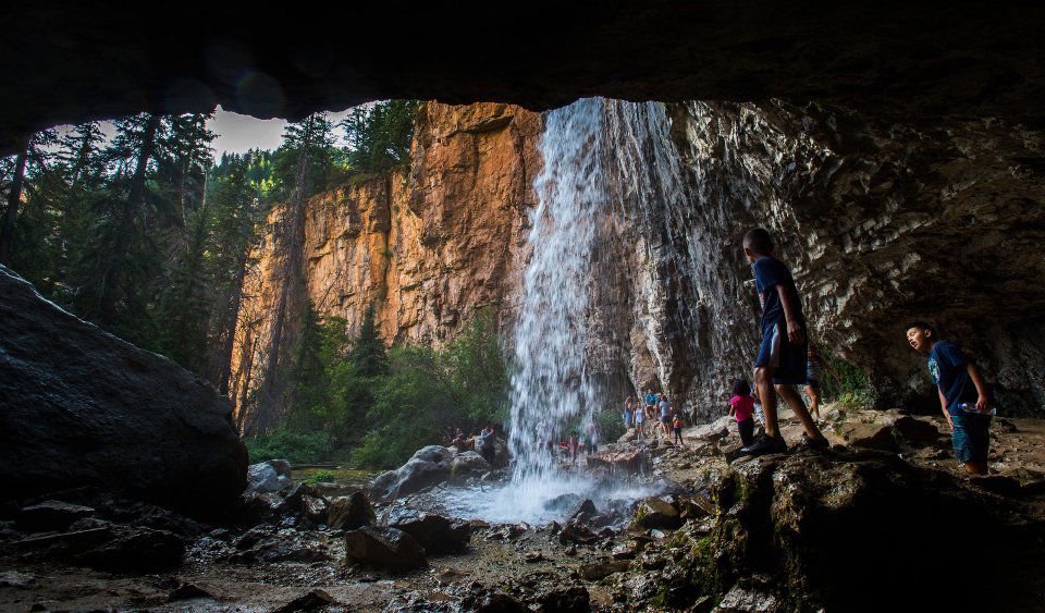 Hikers play in at Spouting Rock above Hanging Lake in Glenwood Canyon